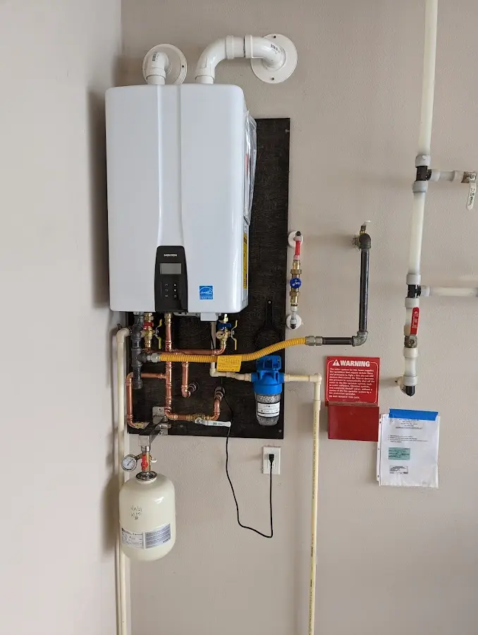 Professional plumber installing copper piping in a Chestnut Ridge home